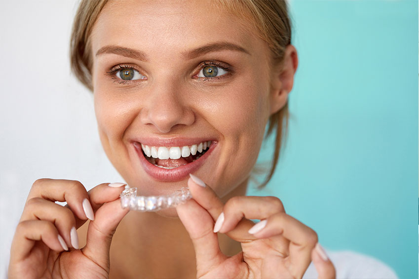 Woman with Invisalign aligners